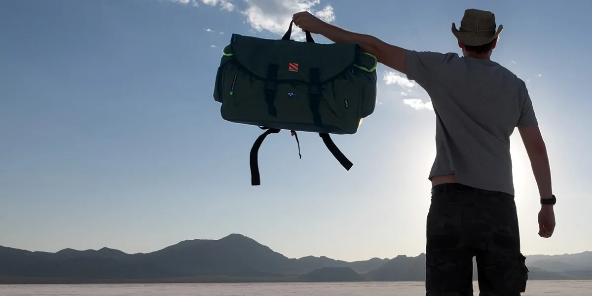 Holding Backpack Bed Outside